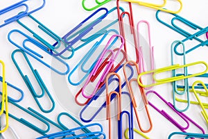 A pile of colorful paperclips on white background, Close-up