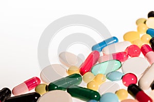 Pile of colorful pills and capsules on white background