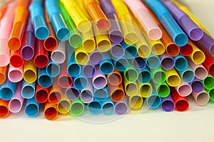 Pile of colorful plastic drinking straws. Close up