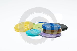 Pile of colorful sewing plastic buttons on white background