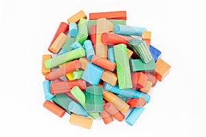 A pile of colorful wooden building blocks of different shapes and colors on isolated white background