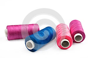 Pile of coloured bobbins of lurex thread