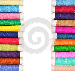 Pile of coloured bobbins of lurex thread isolated on white