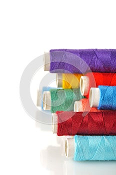 Pile of coloured bobbins