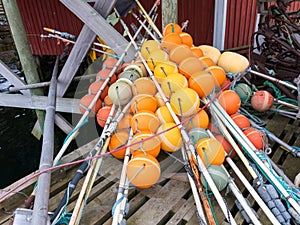 Pile of colourful plastic floats outside a fishing hut in Moskenes, Moskenesoya, Lofoten islands, Nordland, Norway