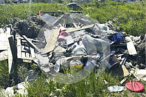 A pile of construction garbage on a green glade