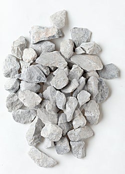 Pile of construction gravel stone lie in group, gray rock gravel show close up texture and dust, object design. White background