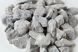 Pile of construction gravel stone lie in group, gray rock gravel show close up texture and dust, object design. White background