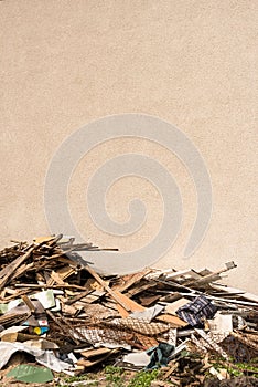 Pile of construction waste and blank wall - building, timber, bo