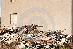 Pile of construction waste and blank wall - building, timber, bo