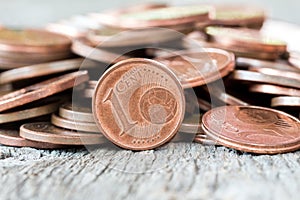 Pile of copper coins on wooden background