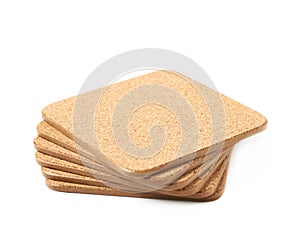 Pile of cork textured coasters isolated