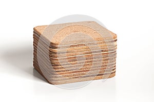Pile of cork textured coasters isolated