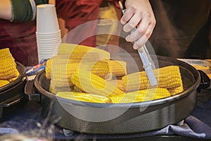 Pile of corn cobs for grill cooking, street diet fast food