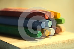 Pile of crayons on a wooden surface