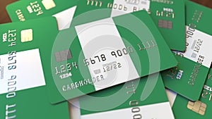 Pile of credit cards with flag of Nigeria. Nigerian banking system conceptual 3D rendering