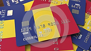 Pile of credit cards with flag of Romania. Romanian banking system conceptual 3D rendering