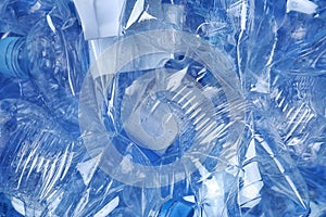 Pile of crumpled plastic bottles as background, closeup.