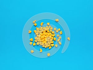 A pile of crumpled yellow pieces of paper on a blue background. Minimal business concept