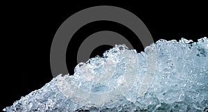 Pile of crushed ice cubes on dark background with copy space. Crushed ice cubes foreground for beverages, beer, whisky, fruit