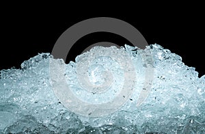 Pile of crushed ice cubes on dark background with copy space. Crushed ice cubes foreground for beverages, beer, whisky, fruit