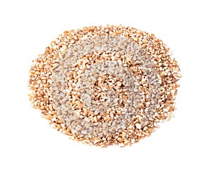 Pile of crushed wheat groats closeup on white