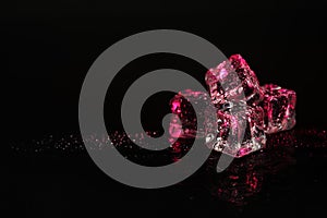 Pile of crystal clear ice cubes on black background.