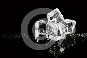 Pile of crystal clear ice cubes on black background.