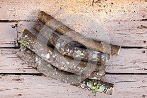 Pile of cut logs of firewood over a wooden boards background, sawed fire wood photo