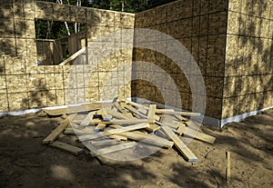 Pile of cut wood board scraps, left in a heap at a constuction site photo