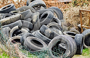 A pile of damaged, old, discarded, car tires for recycling