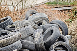 A pile of damaged, old, discarded, car tires for recycling