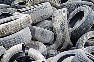 A pile of damaged, old, discarded, car tires for recycling