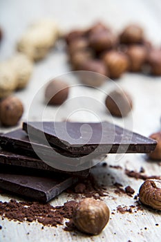 Pile of dark chocolate with nuts and nutshells