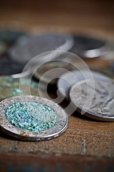 Pile of different ancient copper coins ccloseup on rustic wooden table background