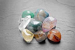 Pile of different beautiful gemstones on grey