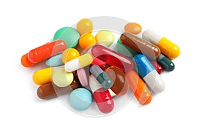 Pile of different colorful pills on white background, above view