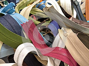 A pile of different coloured zips and zippers