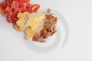 Pile of different dried fruits on white background, top view. Space for text