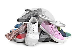 Pile of different shoes on white