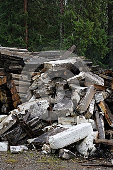 Pile of dirty styrofoam and weathered baulk timber