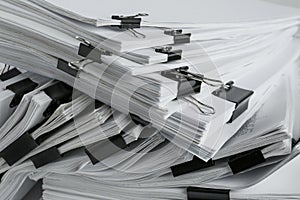 Pile of documents with binder clips,