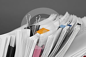 Pile of documents with colorful binder clips