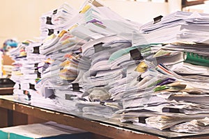 Pile of documents on desk stack up high