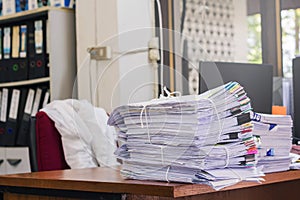 Pile of documents on desk stack up