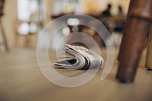 Pile of dollar banknote drops on the floor at public