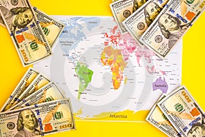 Pile of dollars near USA on world map, money, dollar and world map view from above. Text field, Copy space