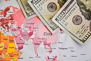 Pile of dollars near USA on world map, money, dollar and world map view from above. Text field, Copy space