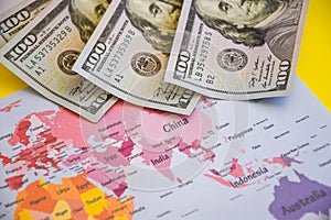 Pile of dollars near USA on world map, money, dollar and world map view from above. Text field, Copy space