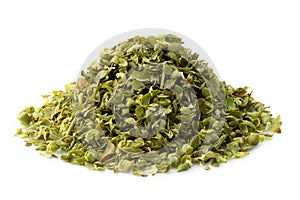 A pile of dried chopped oregano isolated on white